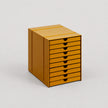 Yellow metal file cabinet with multiple drawers on a white background