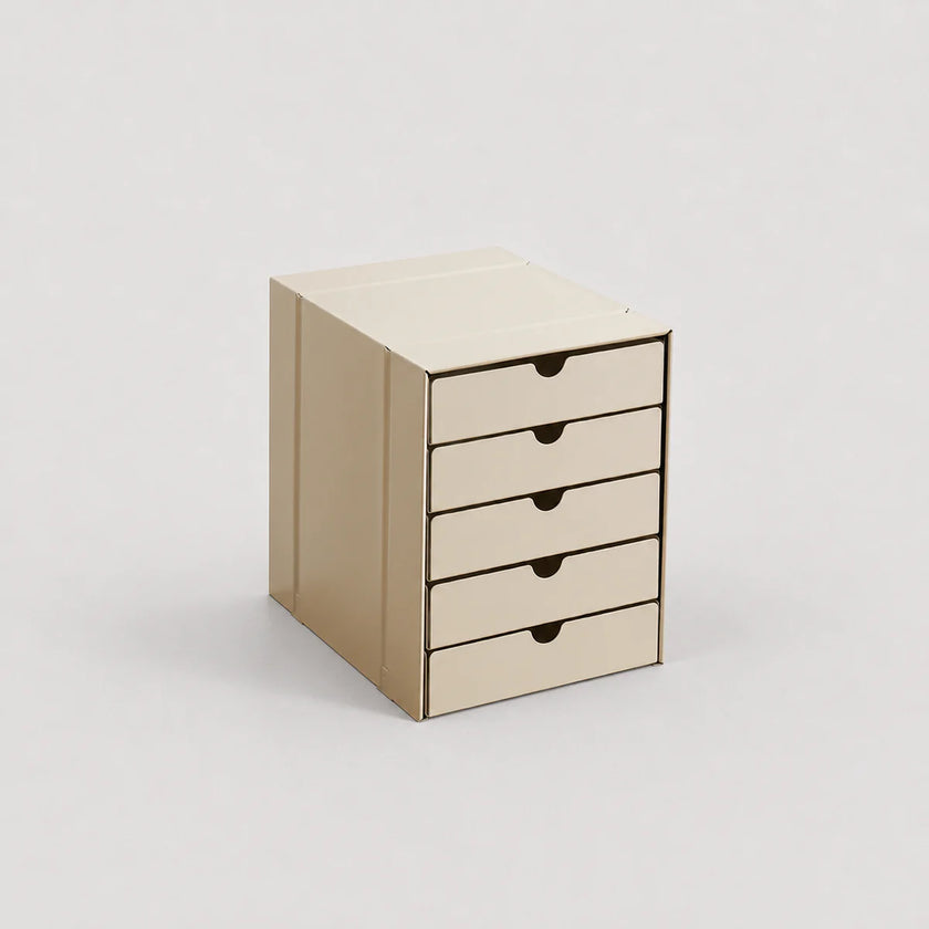 Beige cardboard storage box with four drawers on a light gray background