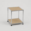 A modern two-tier modular side table with a chrome metal frame and beige panels on a light gray background.