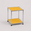 A modern two-tier modular side table with a chrome metal frame and yellow panels on a light gray background.