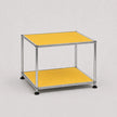 A two-tier modular side table featuring a chrome steel frame and yellow shelves, set against a neutral light gray background.