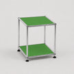 A modern two-tier side table with a chrome silver metal frame and bright green panels on the top and bottom shelves, set against a plain light gray background.