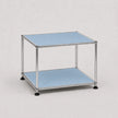 A two-tier modular storage shelf with a chrome metal frame and light blue metal panels, shown on a neutral light gray background.