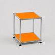 A modern two-tier modular side table with a chrome metal frame and orange panels on a light gray background.