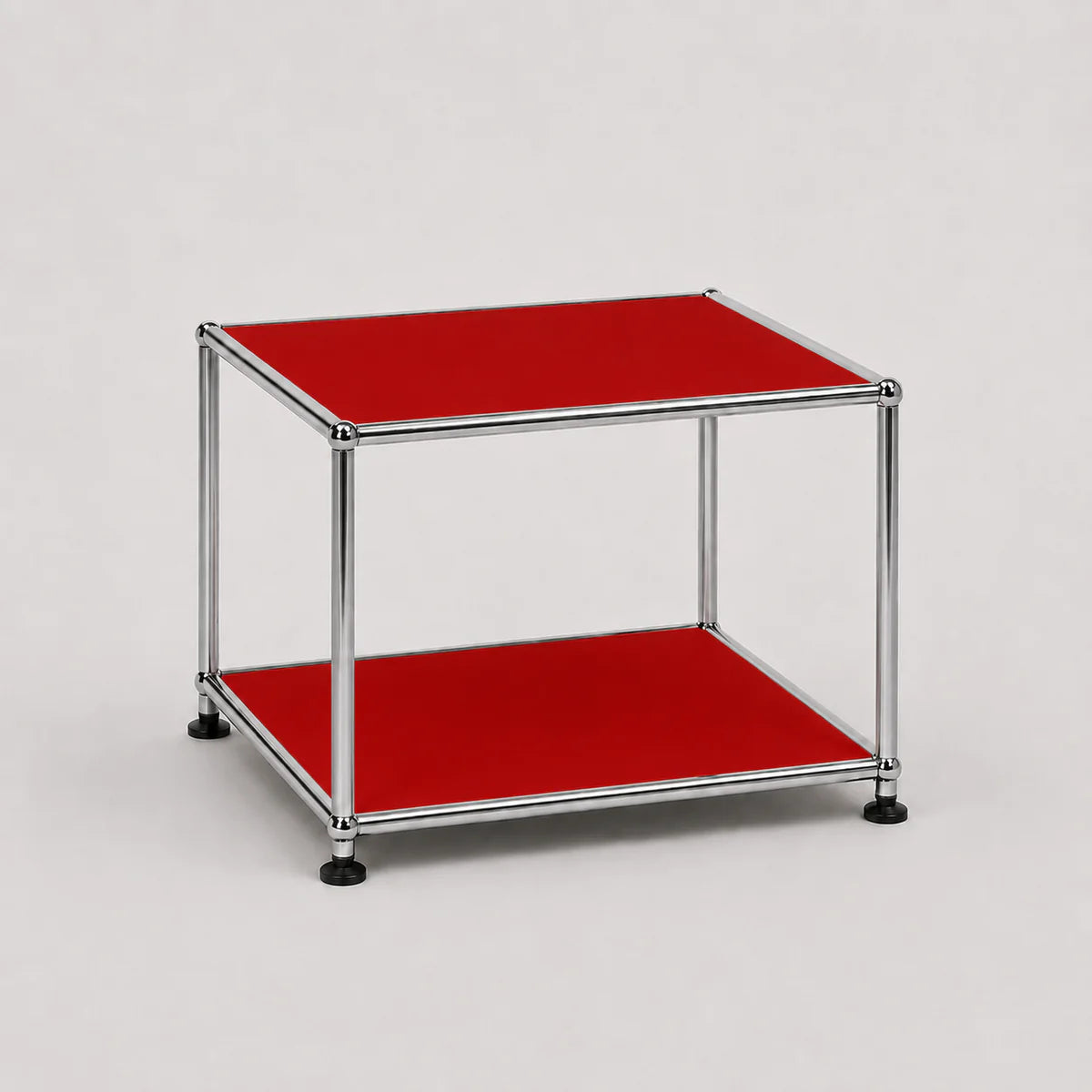 A modern two-tier modular side table featuring a chrome steel frame and ruby red panels on both the top and bottom shelves, set against a neutral light gray background.
