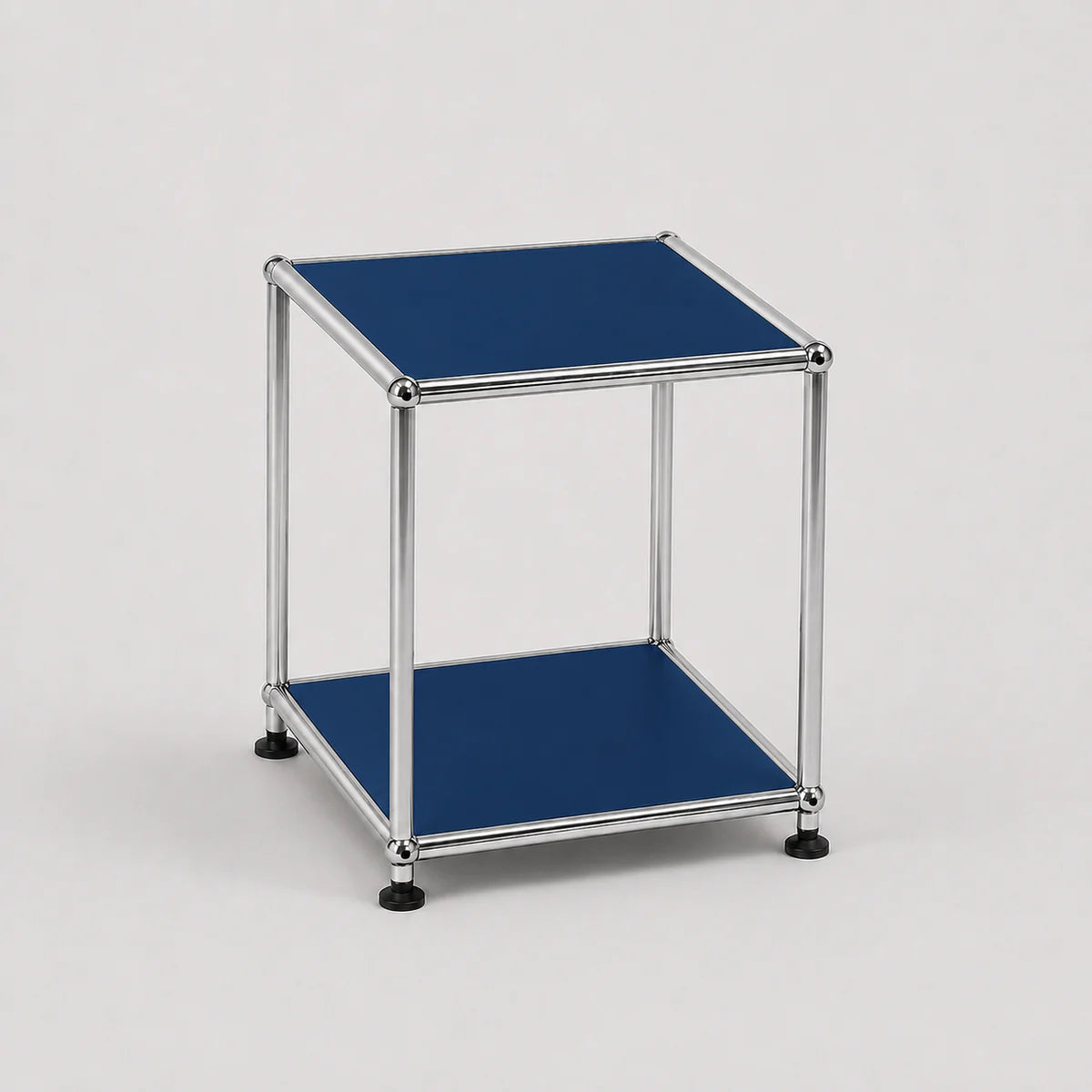 A modern two-tier modular side table with a chrome metal frame and steel blue metal-covered shelves, shown on a light gray background.