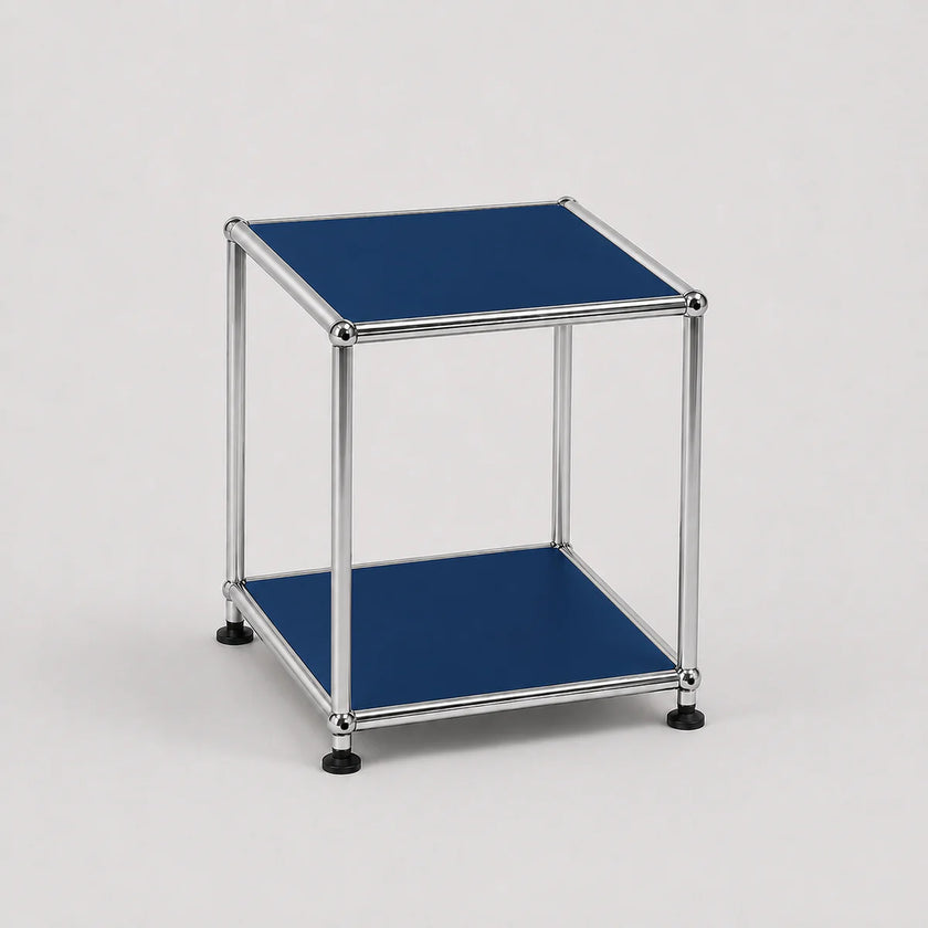 A modern two-tier modular side table with a chrome metal frame and steel blue metal-covered shelves, shown on a light gray background.