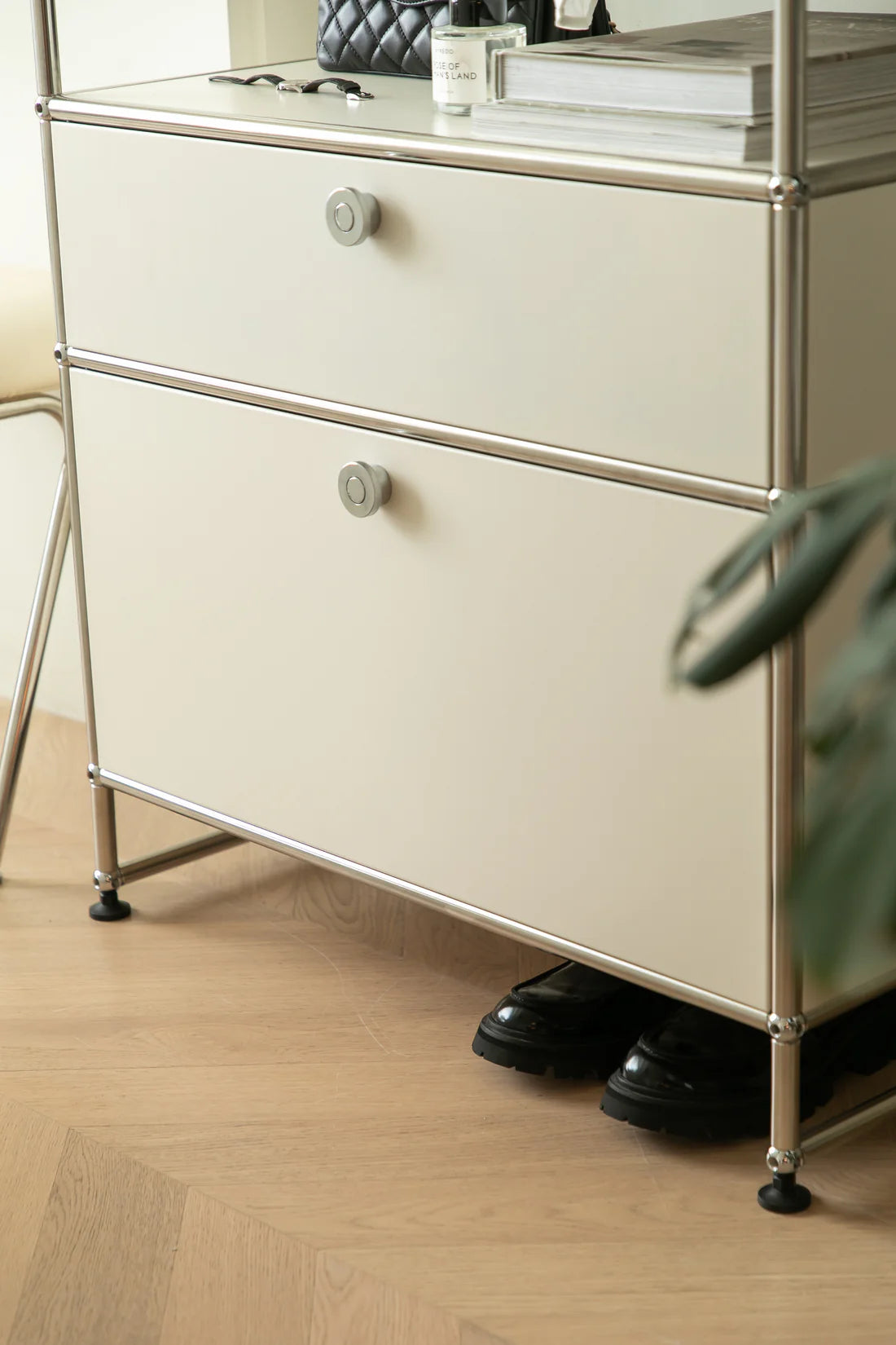 Beige replica USM modular metal cabinet with two drawers on a wooden floor