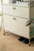 Beige replica USM modular metal cabinet with two drawers on a wooden floor