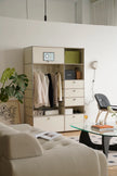 Modern living room with a replica USM modular wardrobe and a glass coffee table.
