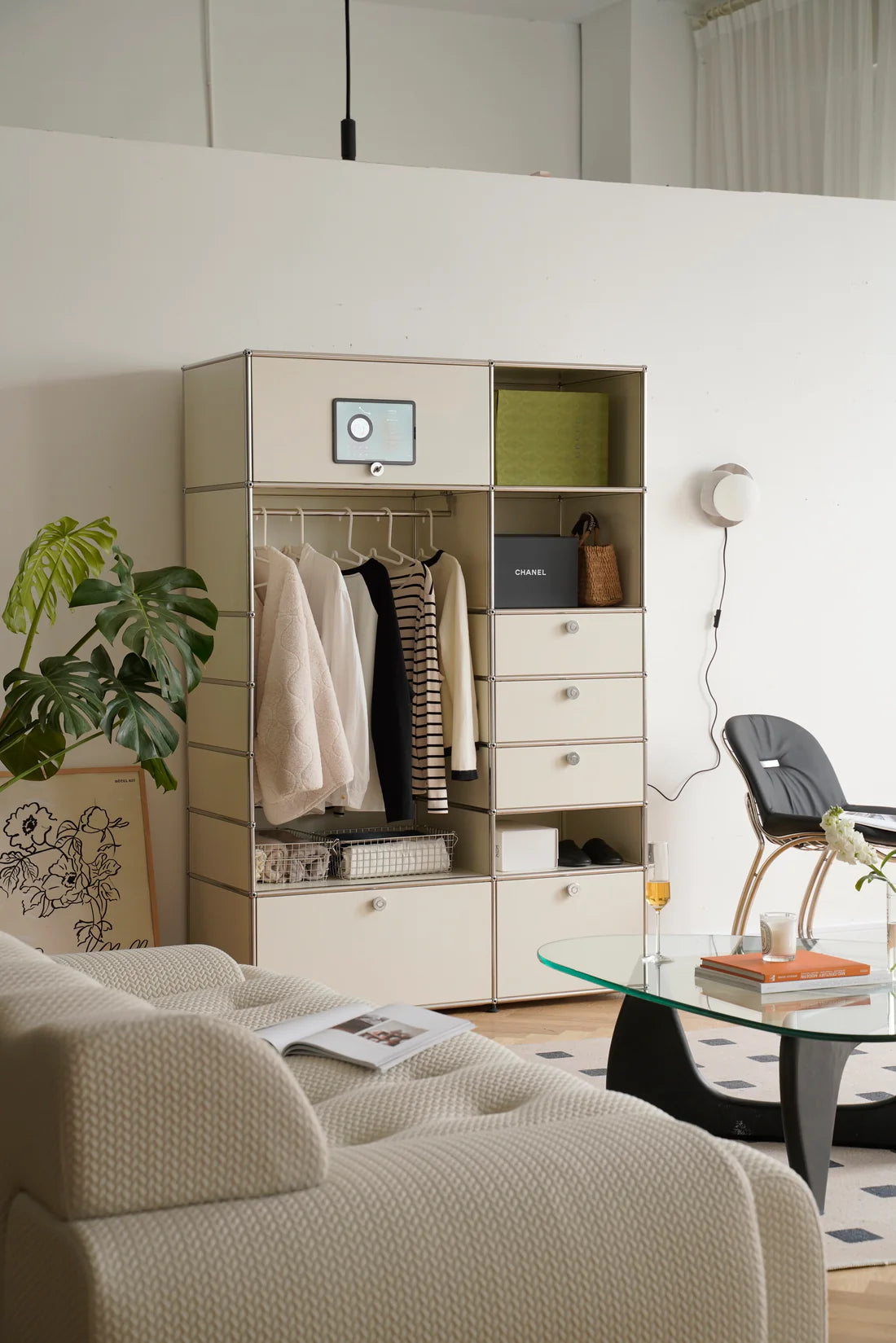 Modern living room with a replica USM modular wardrobe and a glass coffee table.