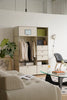 Modern living room with a replica USM modular wardrobe and a glass coffee table.