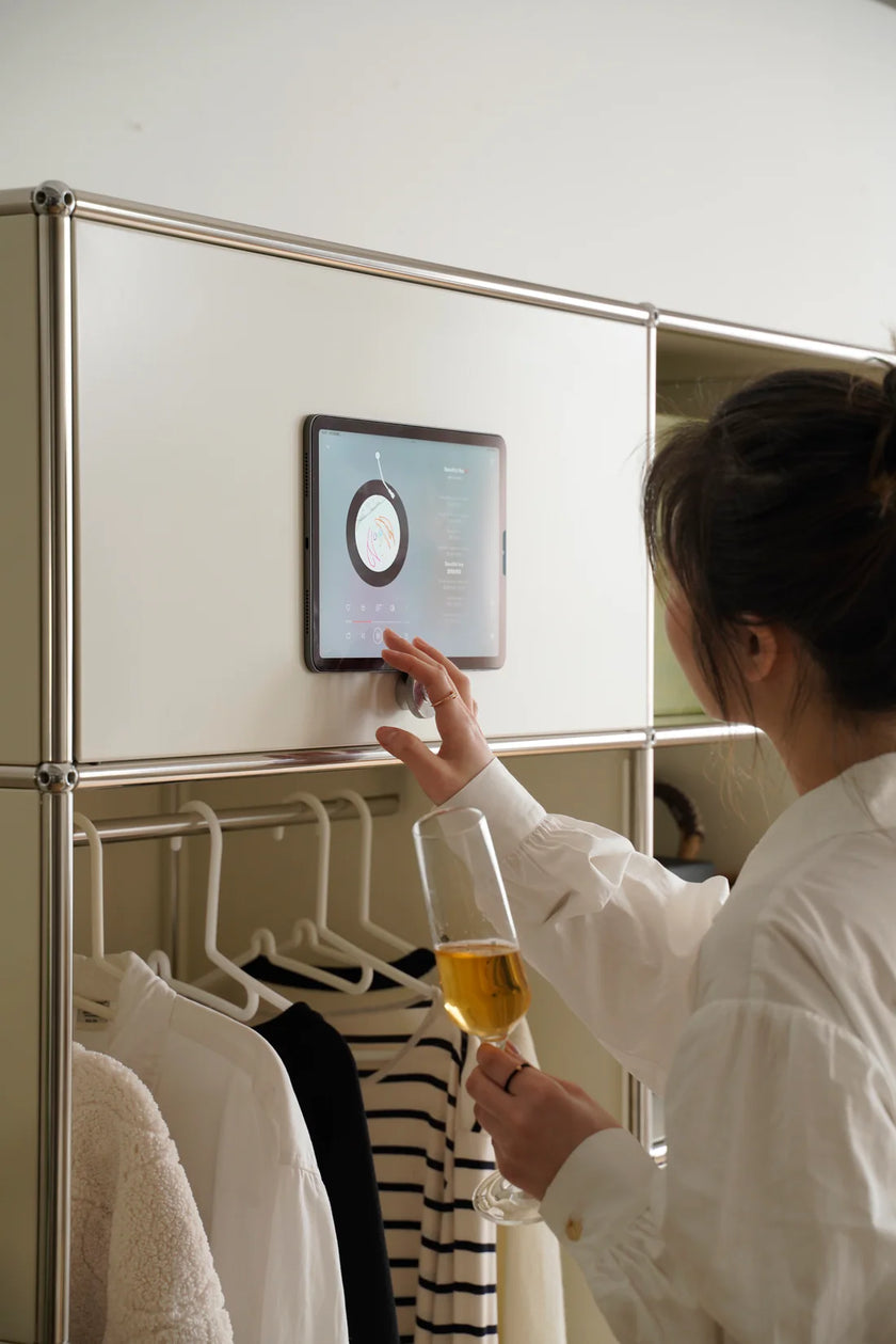 Lady interacting with a smart refrigerator in a inspired recreation USM modular wardrobe setting
