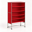 A modular metal storage cabinet with five open shelves, featuring a silver chrome frame, red-colored panels, and black rubber feet, shown on a white studio background.