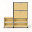 A modular storage cabinet with a light yellow metal finish and a chrome metal frame, featuring two upper drawers with round silver knobs and four lower open shelves, set against a plain white background.