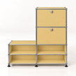 A modular storage organizer with a warm yellow metal panel design and a chrome metal frame, featuring two upper drawers with round silver knobs and four lower open shelves, set against a plain white background.