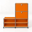 An orange modular storage cabinet with a chrome metal frame and black feet, featuring two upper doors with round silver knobs and four open shelves on the left side, set against a plain white background.