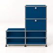 A modular storage cabinet system with dark blue metal panels and a chrome metal frame, featuring two upper cabinets with round silver knobs and four lower open shelves, set against a plain white background.