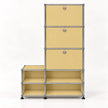 A modular storage organizer made of beige matal panels and silver metal tubing, featuring three drawers on the right with round silver knobs and four open shelves on the bottom, set against a plain white background.