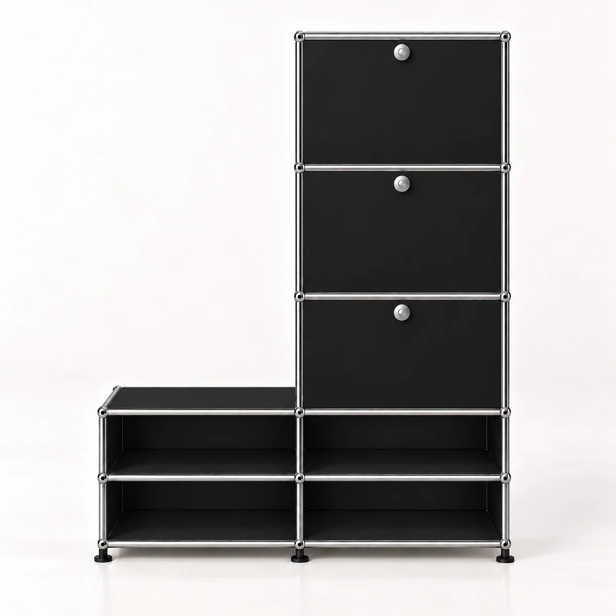 A modular black storage cabinet with a silver metal frame, featuring three drawers on the upper right with round silver knobs and four open shelves on the lower, set against a plain white background.
