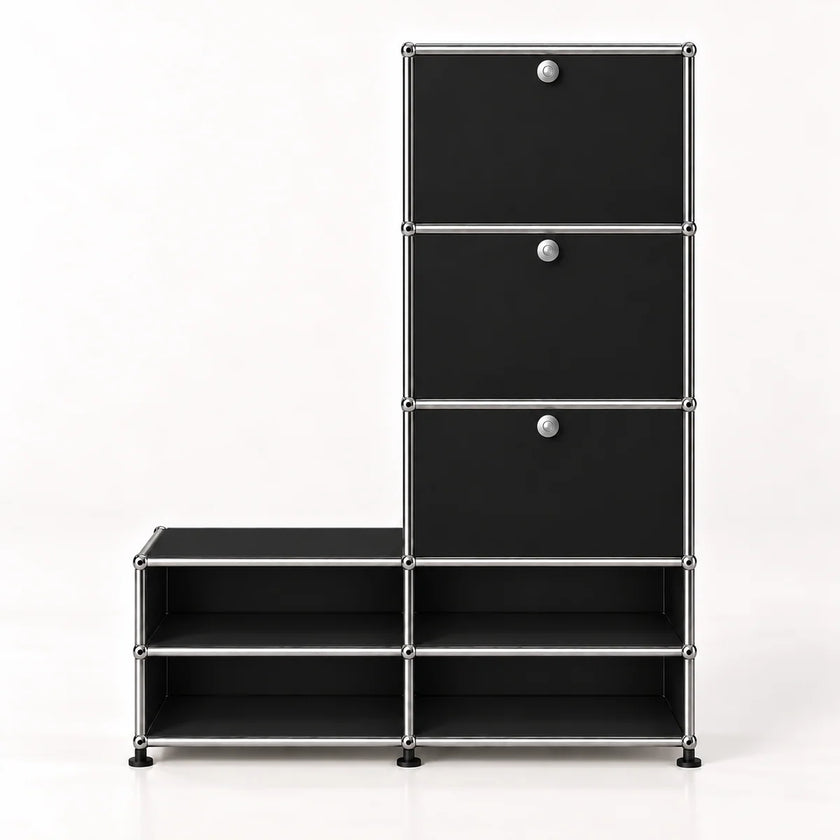 A modular black storage cabinet with a silver metal frame, featuring three drawers on the upper right with round silver knobs and four open shelves on the lower, set against a plain white background.