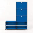 A modular storage cabinet with a bright blue fabric drawer and open shelf compartments connected by a silver metal frame, shown on a clean white background.