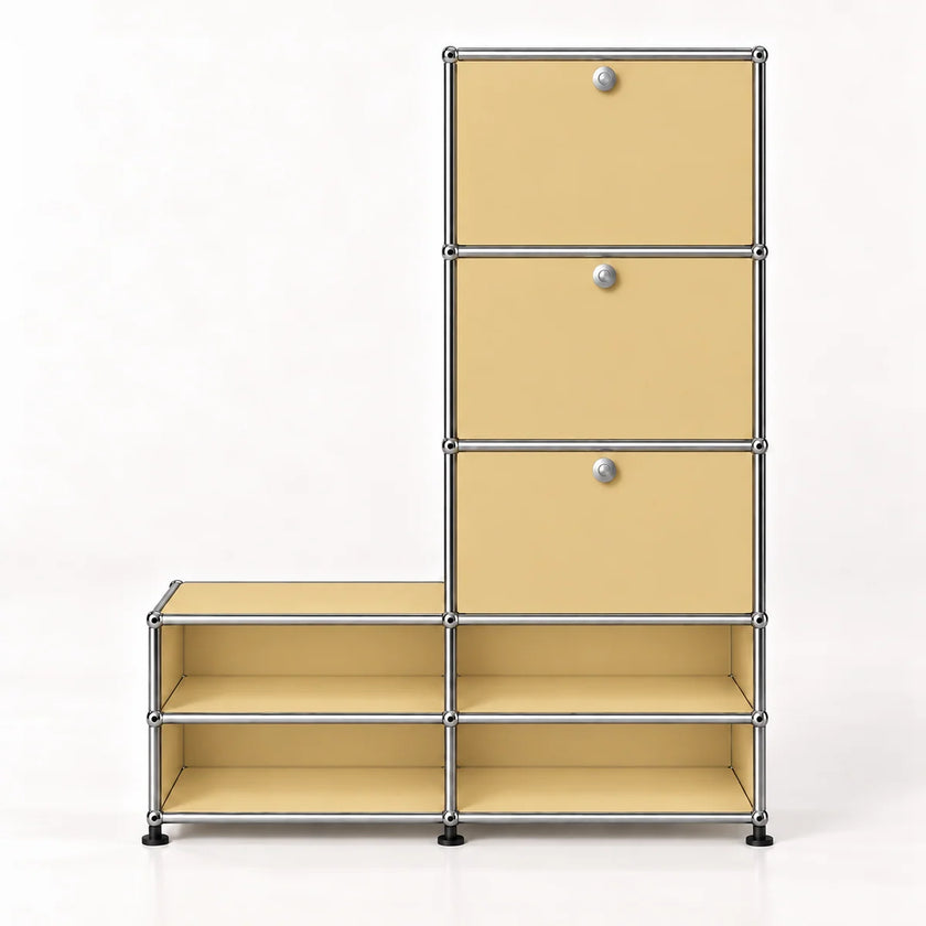 A modular storage cabinet and shelf unit with three drawers on the right and open shelves, finished in warm beige metal panels with a chrome metal frame and small round silver knobs.