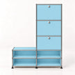 A modular storage cabinet with a light blue finish and a chrome metal frame, featuring three drawers on the upper right with round silver knobs and four open shelves on the lower.