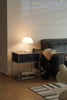 Modern living room with a replica USM modular side table, lamp, and sofa.