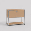 A modern modular two-tier storage cabinet with a silver chrome wire frame, tan canvas panels, and a silver round lock on the upper drawer front, set against a neutral light gray background.