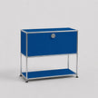 A modern modular two-tier storage cabinet with a bright blue enamel finish and a chrome-plated tubular steel frame, featuring a lock on the upper door.