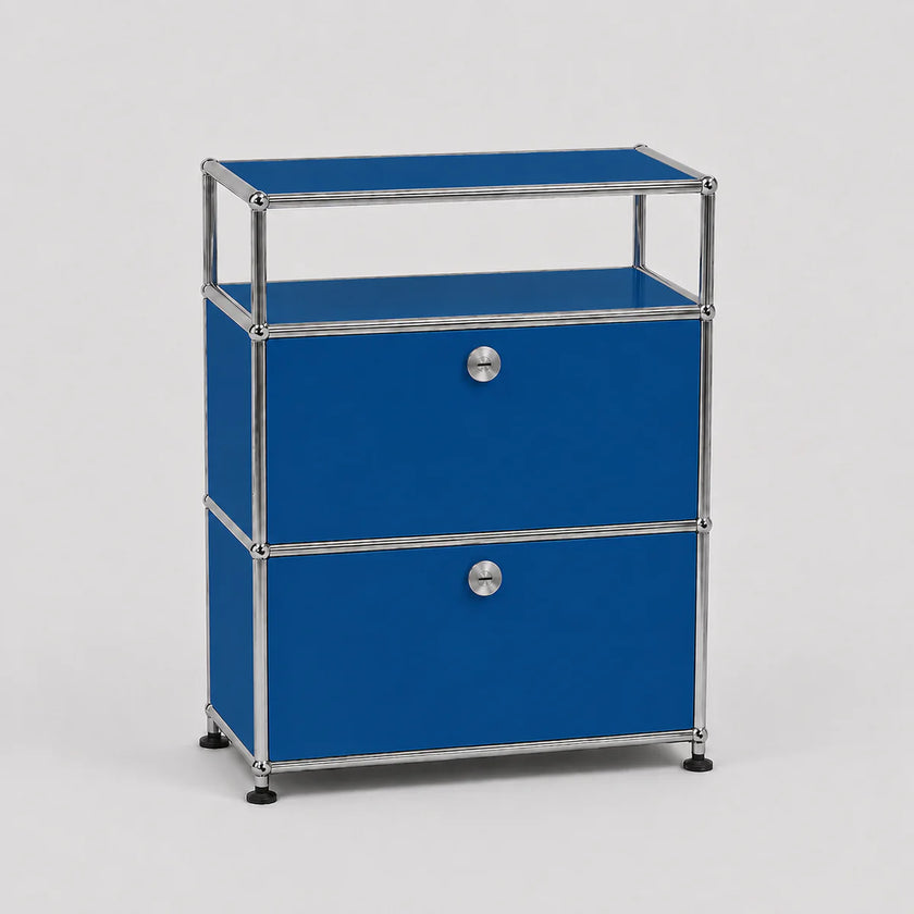 A modular two-drawer storage cabinet with vibrant blue panels and a chrome metal frame, featuring round silver knobs and black feet, set against a light gray background.