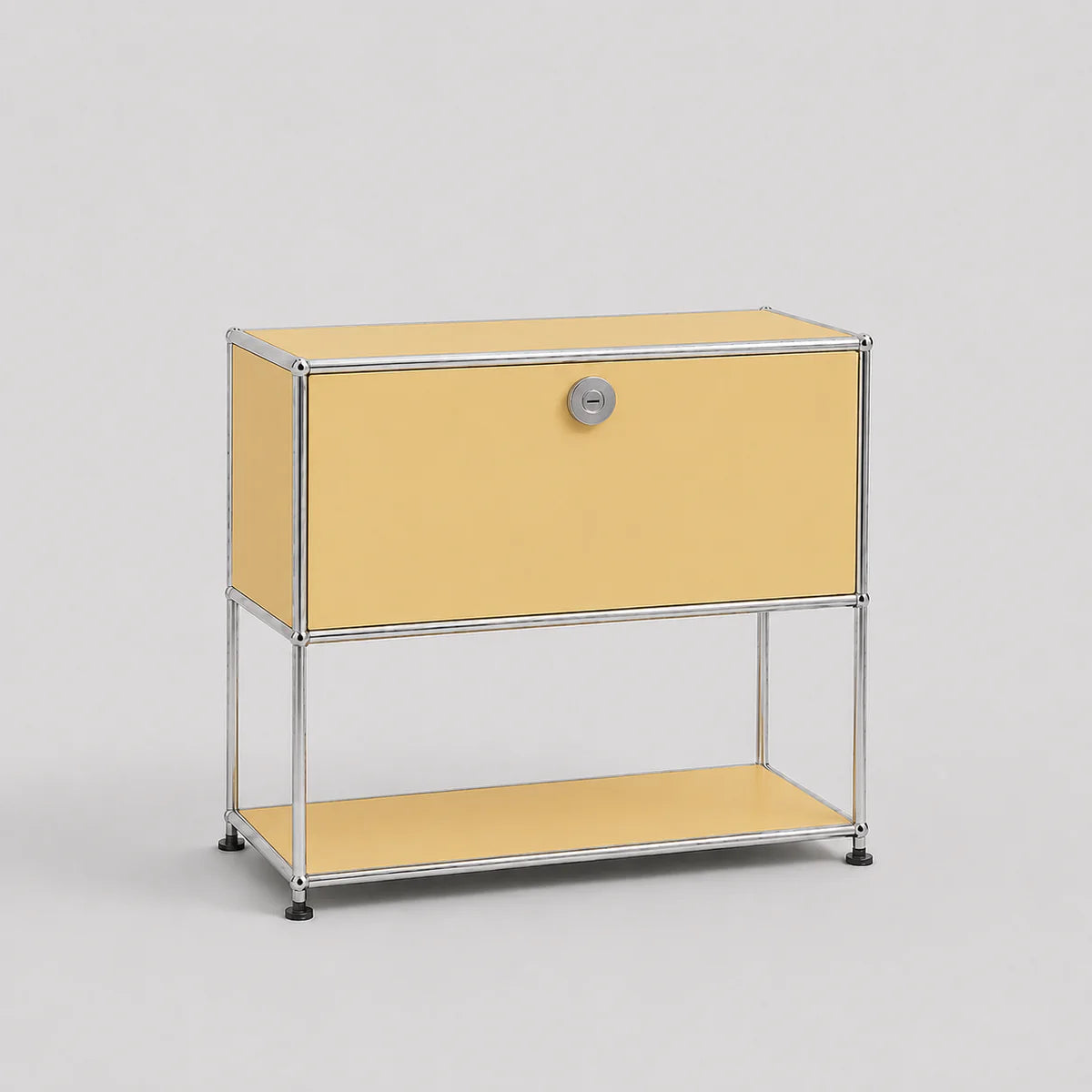 A modern modular two-tier storage cabinet with a pale yellow enamel finish and a chrome-plated tubular steel frame, featuring a single lock on the upper drawer front.