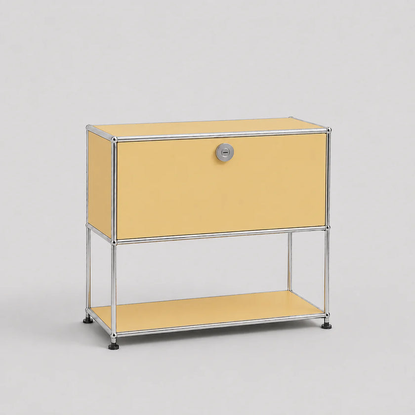 A modern modular two-tier storage cabinet with a pale yellow enamel finish and a chrome-plated tubular steel frame, featuring a single lock on the upper drawer front.