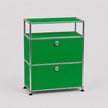 A green two-drawer modular storage cabinet with a chrome metal frame and round silver knobs, set against a light gray background.