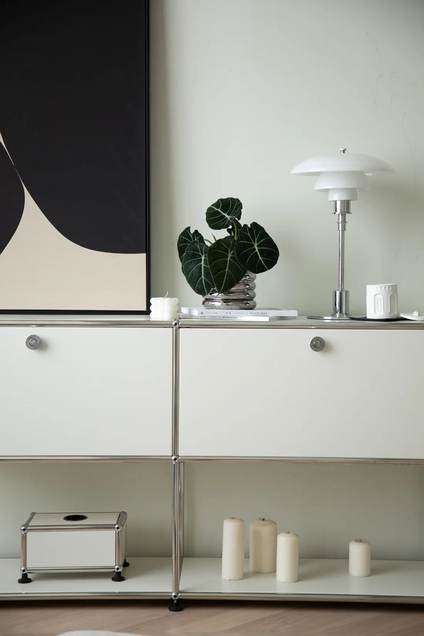Modern interior with inspired recreation USM modular white cabinets, a plant, and a lamp.