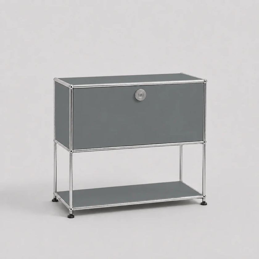 A modern gray modular storage cabinet with a single lockable door and an open lower shelf, supported by a slim chrome metal frame, shown against a light gray background.