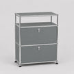 A modern two-drawer modular storage cabinet with gray panels and a chrome metal frame, featuring a top shelf and round silver knobs.