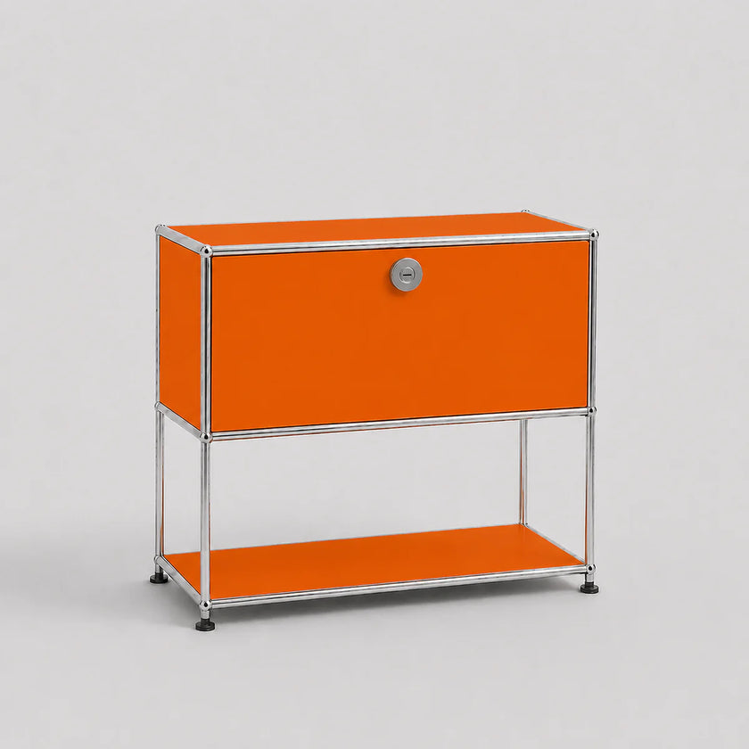 An orange modular storage cabinet with a silver metal frame, featuring a single lockable door with a round silver handle and an open lower shelf, set against a light gray background.