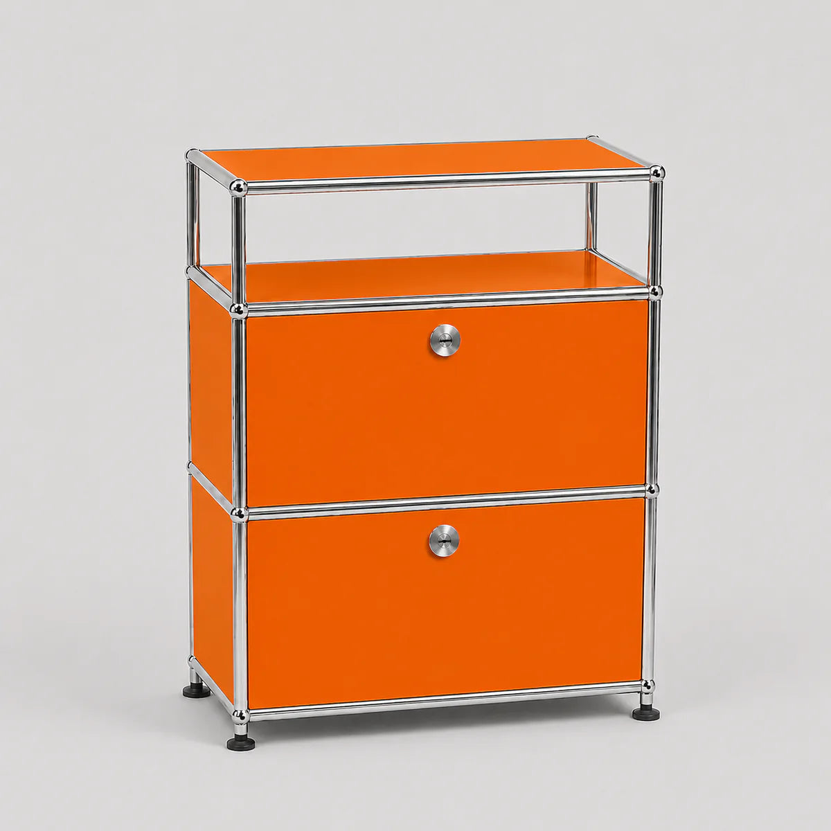 Bright orange modular storage cabinet with two drawers and an open top shelf, framed in polished chrome metal with small black feet, on a light gray background.