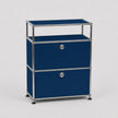 A modern modular two-drawer storage cabinet with a deep blue fabric finish and a chrome metal frame, featuring round silver knobs and black feet, set against a light gray background.