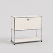 A modern modular two-tier nightstand with a chrome wire frame and cream-colored panels, featuring a single drawer on the top tier and an open shelf on the bottom, set against a plain light gray background.