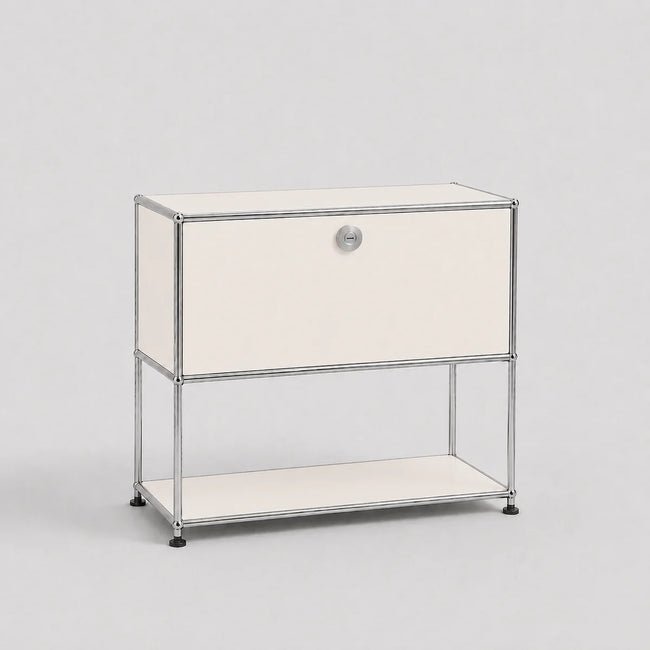A modern modular two-tier nightstand with a chrome wire frame and cream-colored panels, featuring a single drawer on the top tier and an open shelf on the bottom, set against a plain light gray background.