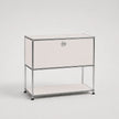 A modern two-tier storage cabinet with a white front panel, a silver metal frame, and a small round silver knob on the upper drawer front, set against a light gray studio background.