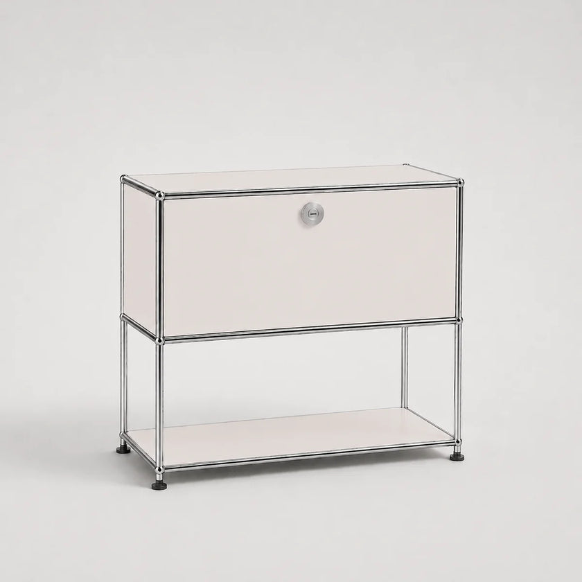 A modern two-tier storage cabinet with a white front panel, a silver metal frame, and a small round silver knob on the upper drawer front, set against a light gray studio background.
