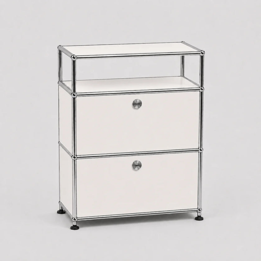 A modern modular two-drawer storage cabinet with a chrome metal frame, white drawer fronts, and a clear glass top shelf, set against a neutral light gray background.