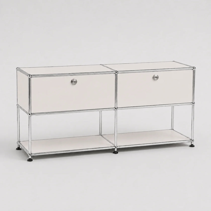 A modern two-drawer storage cabinet with a chrome wire frame, white drawer fronts, round silver knobs, and a lower open shelf, photographed on a light gray studio background.