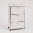 Three-drawer storage cabinet with white metal doors and a chrome metal frame, shown on a light gray background.