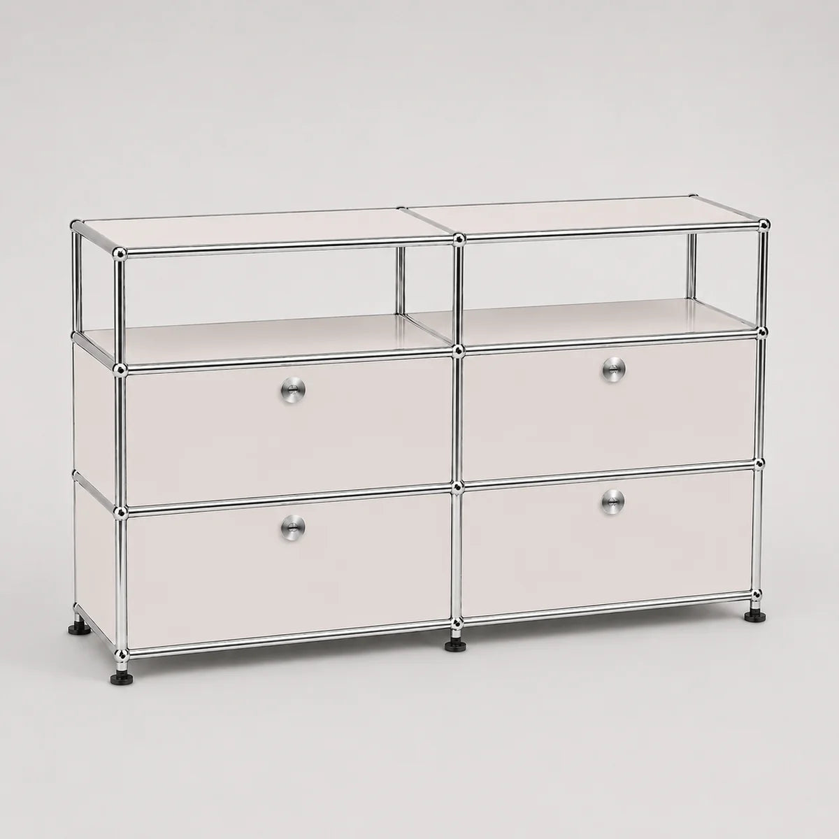 A modular storage cabinet with a chrome metal frame, featuring four drawers arranged in two columns of three, with small round silver knobs and black feet, on a light gray background.