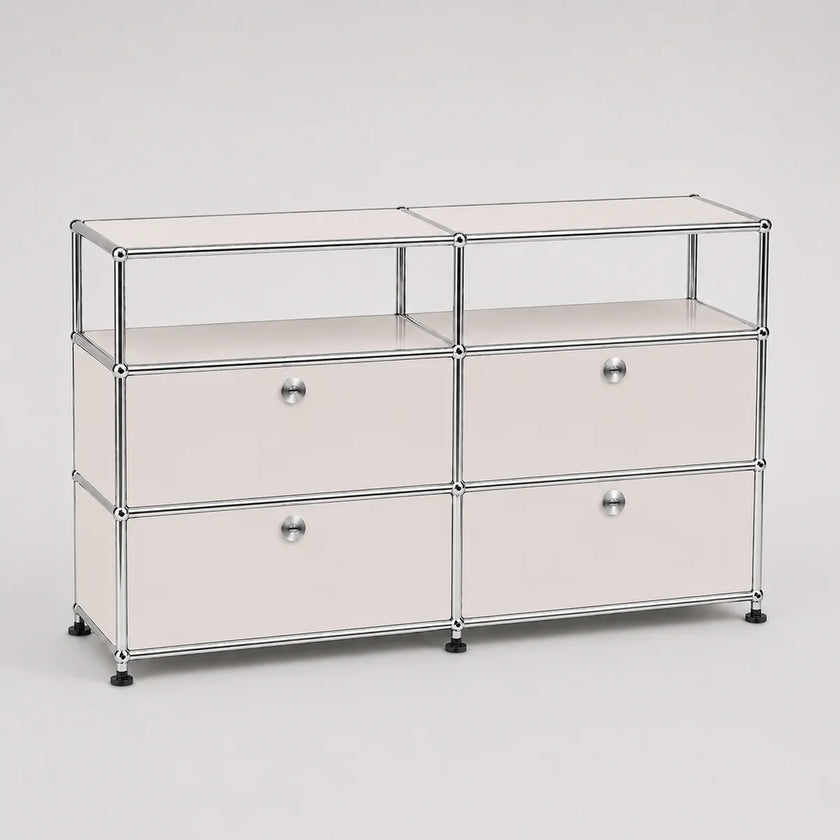 A modular storage cabinet with a chrome metal frame, featuring four drawers arranged in two columns of three, with small round silver knobs and black feet, on a light gray background.